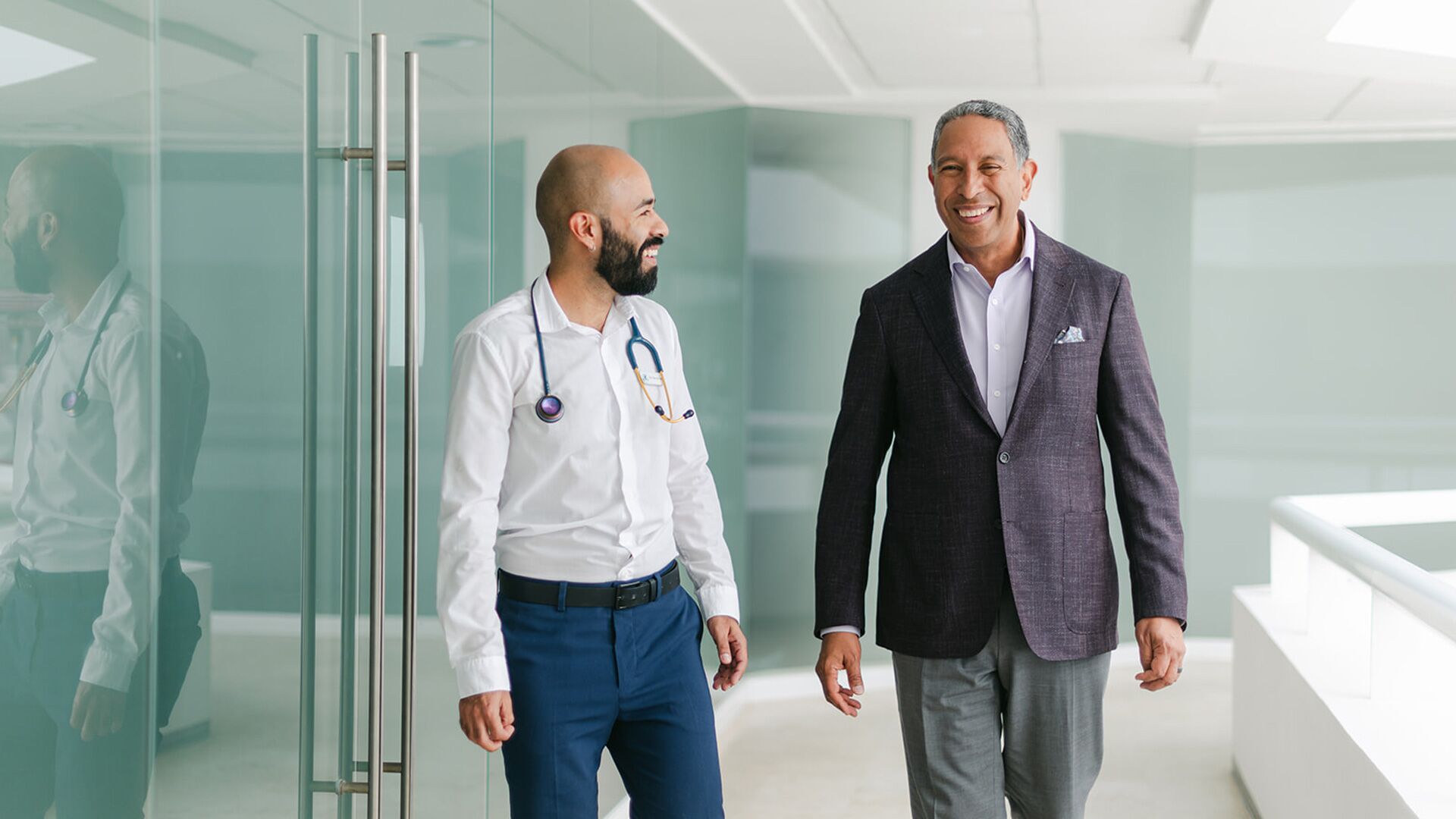 Dr. Tony Jimenez speaking with a doctor at Hope4Cancer
